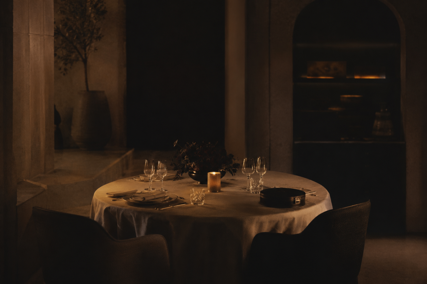 A single candlelit table set for a private evening in a Gulf villa.